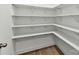Walk-in pantry features white shelving and hardwood floors, providing ample storage space at 7717 Nautical View Dr, Denver, NC 28037