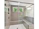 Modern shower design with gray tiling, glass door, and built-in bench, creating a luxurious bathing space at 7717 Nautical View Dr, Denver, NC 28037