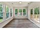 Bright sun room with hardwood floors, lots of windows and a sliding glass door to the outside deck at 7717 Nautical View Dr, Denver, NC 28037