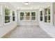 Bright sun room with abundant natural light and multiple windows offering scenic wooded views at 7717 Nautical View Dr, Denver, NC 28037