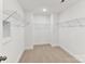 Functional walk-in closet with shelving units, offering ample storage space and organization options at 7717 Nautical View Dr, Denver, NC 28037