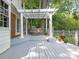 Outdoor seating with porch swing overlooking luscious greenery at 827 Museum Dr, Charlotte, NC 28207