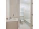 Small bathroom with a toilet and sink and white tile in the shower/tub area at 827 Museum Dr, Charlotte, NC 28207