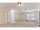 Large bedroom featuring neutral carpet, two closets, and abundant natural light from several windows at 827 Museum Dr, Charlotte, NC 28207