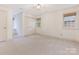 Spacious bedroom features neutral carpet, windows, and ample closet space at 827 Museum Dr, Charlotte, NC 28207