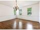 Elegant dining room featuring hardwood floors, chandelier, and bright, large windows at 827 Museum Dr, Charlotte, NC 28207