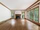Spacious living room with hardwood floors, fireplace and large windows at 827 Museum Dr, Charlotte, NC 28207