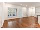Bright living area featuring built-in cabinets, hardwood floors and backyard view at 827 Museum Dr, Charlotte, NC 28207