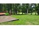 Expansive backyard with a golf course view from the patio and deck, surrounded by mature trees at 9424 Whitethorn Dr, Charlotte, NC 28277