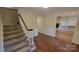 Charming entryway with wood floors and a view of the staircase and the living room at 9424 Whitethorn Dr, Charlotte, NC 28277