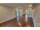 Bright living room features wood floors and natural light from large windows at 9424 Whitethorn Dr, Charlotte, NC 28277