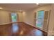 Inviting living room filled with natural light from large windows and wood floors at 9424 Whitethorn Dr, Charlotte, NC 28277