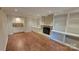 Bright living room boasts a fireplace, shelving and wood floors at 9424 Whitethorn Dr, Charlotte, NC 28277