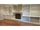 Cozy living room featuring a fireplace, built-in shelving and wood floors at 9424 Whitethorn Dr, Charlotte, NC 28277