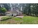 Back of a two-story home featuring a spacious deck, patio, and two-car garage, ideal for entertaining at 9424 Whitethorn Dr, Charlotte, NC 28277