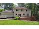 Rear view of a two-story home with a large wooden deck and patio, perfect for outdoor enjoyment at 9424 Whitethorn Dr, Charlotte, NC 28277