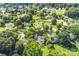 Aerial view showcases a neighborhood with many mature trees, well-manicured lawns, and houses at 953 Milkwood Ln, Monroe, NC 28110