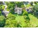 Aerial view of a home with a large backyard, deck, mature trees, and neighboring houses at 953 Milkwood Ln, Monroe, NC 28110