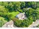 Aerial view shows a property with mature trees, a lawn, and proximity to other houses at 953 Milkwood Ln, Monroe, NC 28110