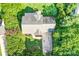 Overhead view of the property shows a tree-lined lawn and a large driveway to the home at 953 Milkwood Ln, Monroe, NC 28110