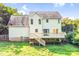 Two-story home featuring a wooden deck, a well-manicured yard, and a neutral exterior at 953 Milkwood Ln, Monroe, NC 28110