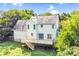Two-story home featuring a wooden deck, a well-manicured yard, and a neutral exterior at 953 Milkwood Ln, Monroe, NC 28110