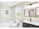 Bathroom with a marble shower, modern vanity, and natural light from a window at 953 Milkwood Ln, Monroe, NC 28110