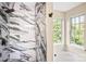 Bathroom showcases a luxurious marble shower, a soaking tub and a view to the outside at 953 Milkwood Ln, Monroe, NC 28110