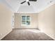 Spacious bedroom featuring a vaulted ceiling, a large window, and neutral decor at 953 Milkwood Ln, Monroe, NC 28110