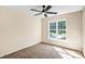 Neutral bedroom featuring a ceiling fan and natural light streaming in from a window at 953 Milkwood Ln, Monroe, NC 28110