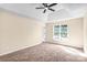 Bedroom with carpeted floor, ceiling fan, neutral paint, and window views at 953 Milkwood Ln, Monroe, NC 28110