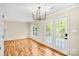 Dining area featuring hardwood floors, contemporary lighting, and views of the outdoors at 953 Milkwood Ln, Monroe, NC 28110