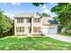 Charming two-story home featuring black shutters, a well-manicured lawn, and an attached two-car garage at 953 Milkwood Ln, Monroe, NC 28110