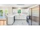 Bright kitchen featuring white cabinets, stainless steel appliances, and elegant marble-look flooring at 953 Milkwood Ln, Monroe, NC 28110