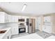 Modern kitchen with white cabinets, stainless steel appliances, and white countertops at 953 Milkwood Ln, Monroe, NC 28110