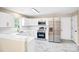 Bright kitchen with stainless steel appliances, white cabinets, and marble tile flooring at 953 Milkwood Ln, Monroe, NC 28110