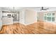 Open concept living area featuring hardwood floors, a stainless steel refrigerator, and modern lighting at 953 Milkwood Ln, Monroe, NC 28110