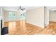 Spacious living room with hardwood floors, a fireplace, ceiling fan, and access to a patio at 953 Milkwood Ln, Monroe, NC 28110