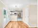 Open concept living area with hardwood floors, stainless steel appliances, and modern lighting at 953 Milkwood Ln, Monroe, NC 28110