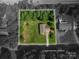 Aerial view showcasing the property lot lines and the house surrounded by lush trees and a well-maintained lawn at 110 Leeper Ave, Belmont, NC 28012