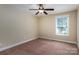Cozy bedroom featuring carpet, a ceiling fan, and a bright window at 110 Leeper Ave, Belmont, NC 28012