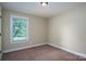 Neutral bedroom with a window providing natural light and carpet at 110 Leeper Ave, Belmont, NC 28012
