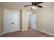 Bedroom offering spacious closets, neutral walls, carpet, and a ceiling fan with lighting at 110 Leeper Ave, Belmont, NC 28012
