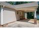 Side of home featuring a convenient carport with brick accents and a white door leading into the house at 110 Leeper Ave, Belmont, NC 28012