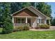 Inviting home featuring a cozy covered porch with white railings and neatly trimmed landscaping at 110 Leeper Ave, Belmont, NC 28012