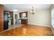Kitchen/Dining area featuring hardwood floors, cabinetry, and modern appliances adjacent to the laundry room at 110 Leeper Ave, Belmont, NC 28012
