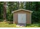 Exterior view of shed, featuring double doors and neutral vinyl siding at 110 Leeper Ave, Belmont, NC 28012