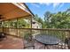 Wooden back porch featuring a metal table with comfortable chairs overlooking a wooded area at 1119 Palmyra Dr, Fort Mill, SC 29708