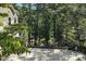 Backyard featuring an iron fence, patio, and mature trees with lake views at 1119 Palmyra Dr, Fort Mill, SC 29708