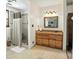 Beautiful bathroom featuring a tiled standing shower with neutral-toned tile and a wooden vanity at 1119 Palmyra Dr, Fort Mill, SC 29708